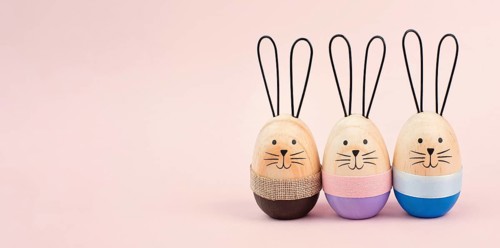 Easter bunny or rabbit group, holiday background and greeting card, painted wooden egg