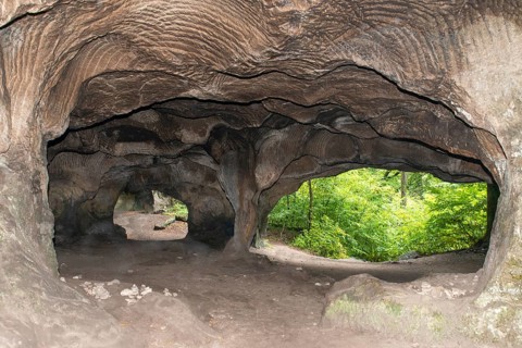 El Huel Lee or Hohllay on the Mullerthal trail in Luxembourg, open cave with view to the forest,