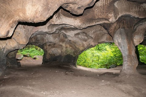 Huel Lee or Hohllay on the Mullerthal trail in Luxembourg, open cave with view to the forest,