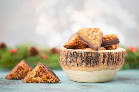 Nut corner triangles, traditional german sweets called Nussecke, covered with chocolate, christmas