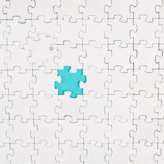 White jigsaw on a blue background, missing parts, working together as a team, searching for