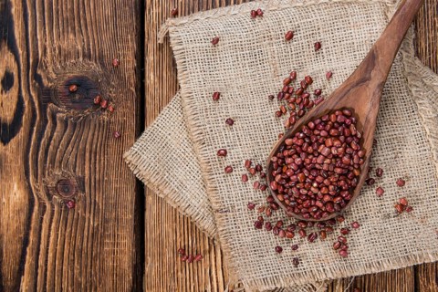 Dried red beans on dark rustic wooden background
