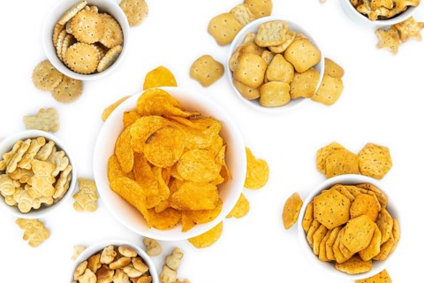 Portion of mixed Snacks isolated on white background (close up shot, selective focus)