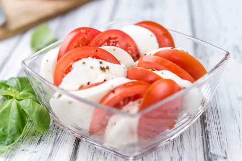 Tomatoes with Mozzarella Cheese (close-up shot, selective focus)