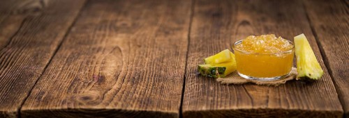 Fresh made Pineapple Jam on a vintage background as detailed close-up shot