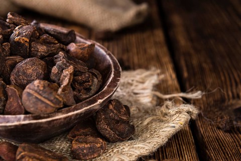 Dried Cola Nuts (whole ones) on vintage wooden background