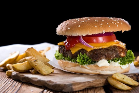Homemade Burger with French Fries on an old wooden table