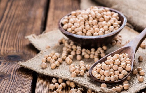 Portion of dried Chick Peas on an old wooden table