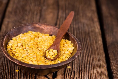 Portion of raw yellow Lentils (detailed close-up shot)