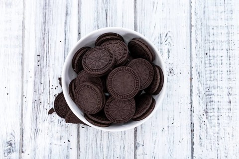 Cream Cookies (close-up shot) on wooden background