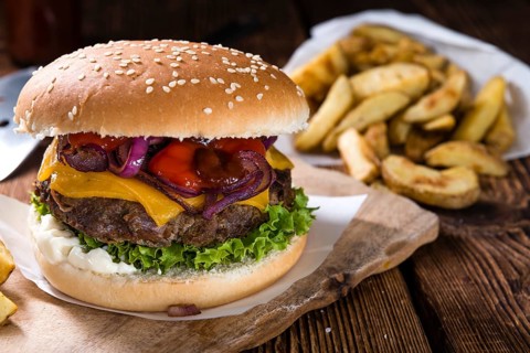 Homemade Burger with French Fries on an old wooden table