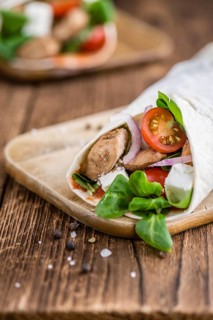 Chicken Wrap (close-up shot, selective focus) on vintage wooden background