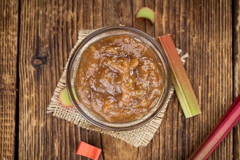 Rhubarb Jam on an old wooden table as detailed close up shot (selective focus)