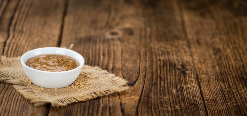 Fresh made German Cuisine (sweet Mustard) on a vintage background (close-up shot)