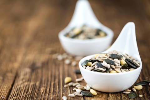 Mixed Seeds (close-up shot, selective focus) on vintage wooden background