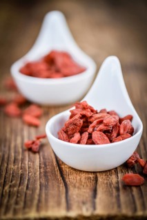 Fresh made Dried Goji Berries on a vintage background (close-up shot)