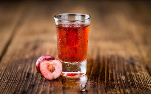 Homemade Cherry Liqueur on vintage background selective focus, close-up shot