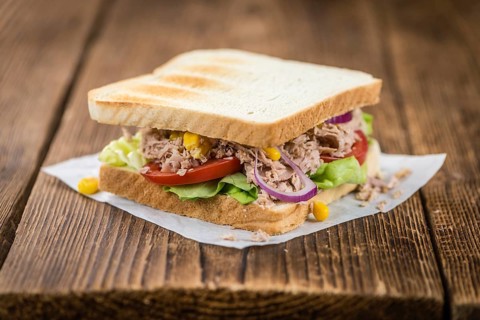 Homemade Tuna Sandwich (selective focus, close-up shot) on vintage wooden background