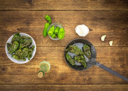 Pimientos de Padron on a vintage background as detailed close-up shot, selective focus