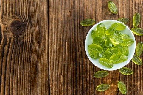 Gummy Candy with lime taste (selective focus) on wooden background