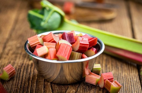 Chopped Rhubarb on an old wooden table (close up shot, selective focus)