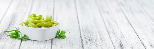 Fresh made Green Chilis (filled with cheese) on a vintage background (close-up shot)
