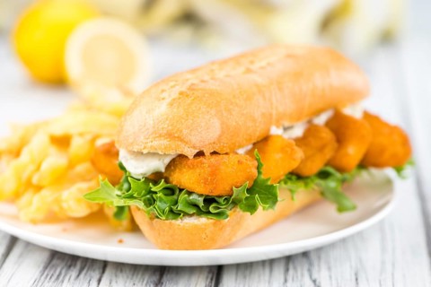 Fresh made Snack (Sandwich with Fish Sticks) on an old wooden table