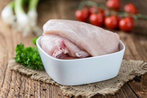 Old wooden table with raw Chicken Cutlet (detailed close-up shot)