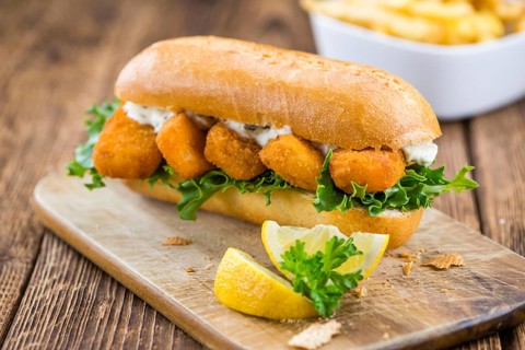 Fresh made Snack (Sandwich with Fish Sticks) on an old wooden table