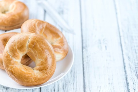 Plain Bagel (selective focus) on vintage background (close-up shot)