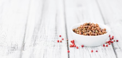 Portion of fresh preserved Pink Peppercorns close-up shot, selective focus
