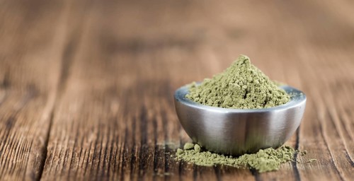 Stevia leaf powder (detailed close-up shot) on rustic wooden background