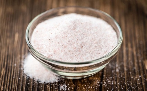 Pink Salt on a vintage background as detailed close-up shot (selective focus)