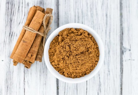 Fresh made Cinnamon Powder on a vintage background (close-up shot)