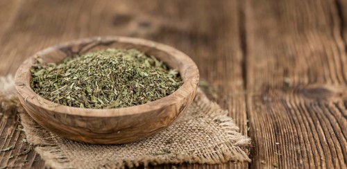 Portion of Stevia Leaves (dried, close-up shot) on wooden background
