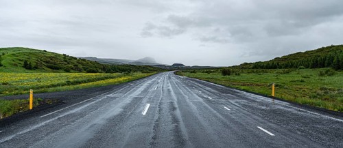 Icelandic street during summer season with spectacular view and green meadows