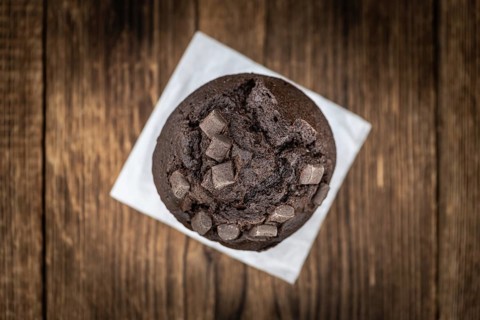 Vintage wooden table with Chocolate Muffins (selective focus, close-up shot)