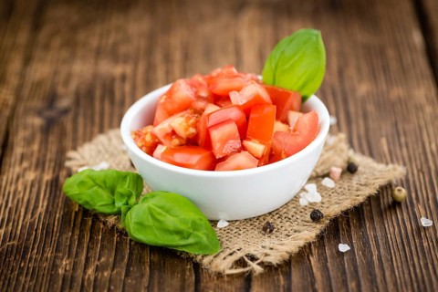 Diced Tomatoes on a vintage background as detailed close-up shot (selective focus)