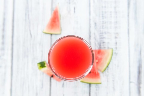 Homemade Watermelon Smoothie on an wooden table (selective focus) as detailed close-up shot