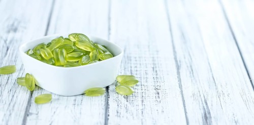 Gummy Candy with lime taste (selective focus) on wooden background