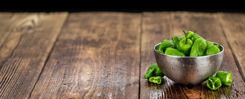 Raw Pimientos on a vintage background as detailed close-up shot, selective focus