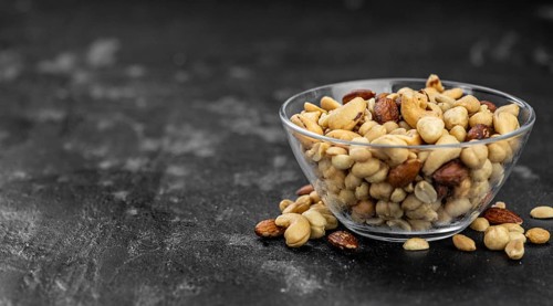 Roasted and salted nuts as detailed close up shot (selective focus)