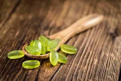 Gummy Candy with lime taste (selective focus) on wooden background