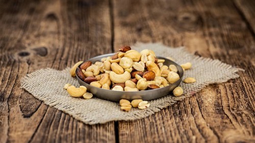 Roasted and salted nuts as detailed close up shot (selective focus)