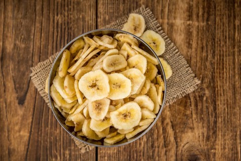 Fresh made Dried Banana Chips on an old and rustic wooden table, selective focus, close-up shot