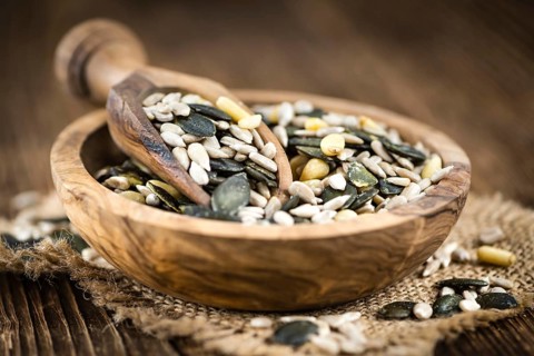Mixed Seeds (close-up shot, selective focus) on vintage wooden background