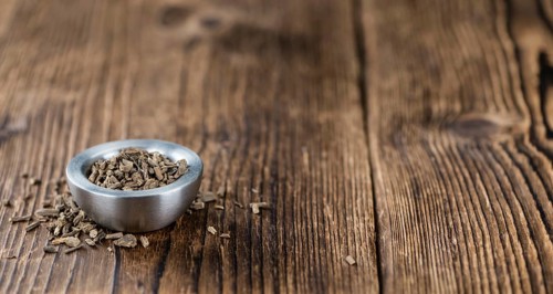 Valerian roots (dried, detailed close-up shot) on wooden background