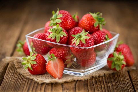 Strawberries on a vintage background as detailed close-up shot, selective focus