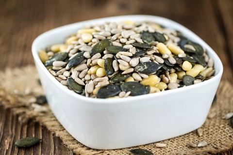 Heap of mixed Seeds (close-up shot) on wooden background