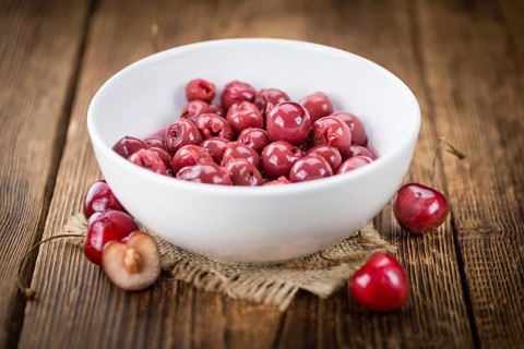 Preserved Cherries on a vintage background as detailed close-up shot, selective focus